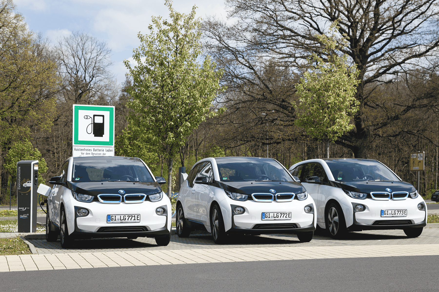3 BMW cars parked in a line using an EV ChargePoint